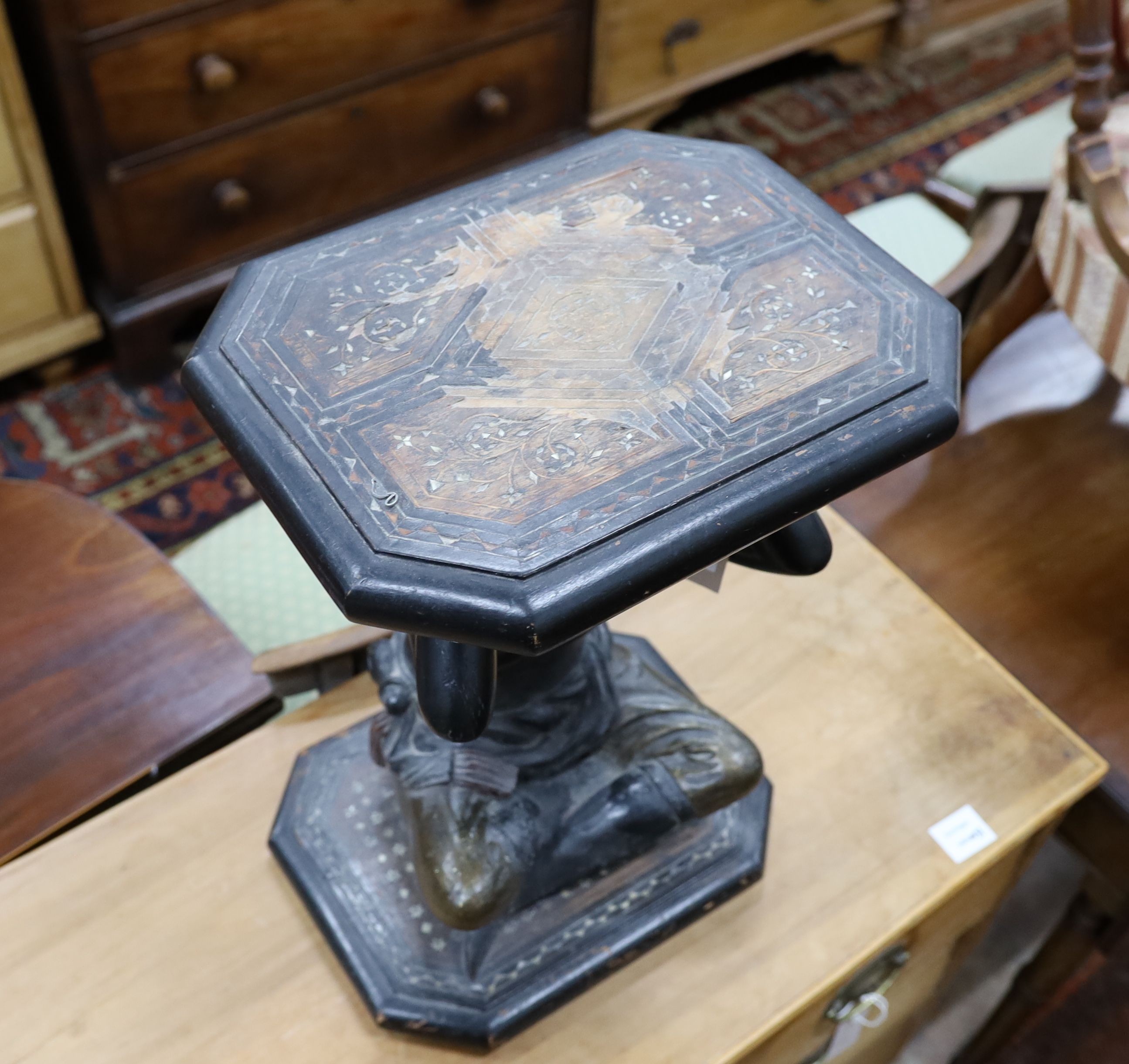 An ebonised wood blackamoor pedestal, width 34cm, depth 28cm, height 49cm